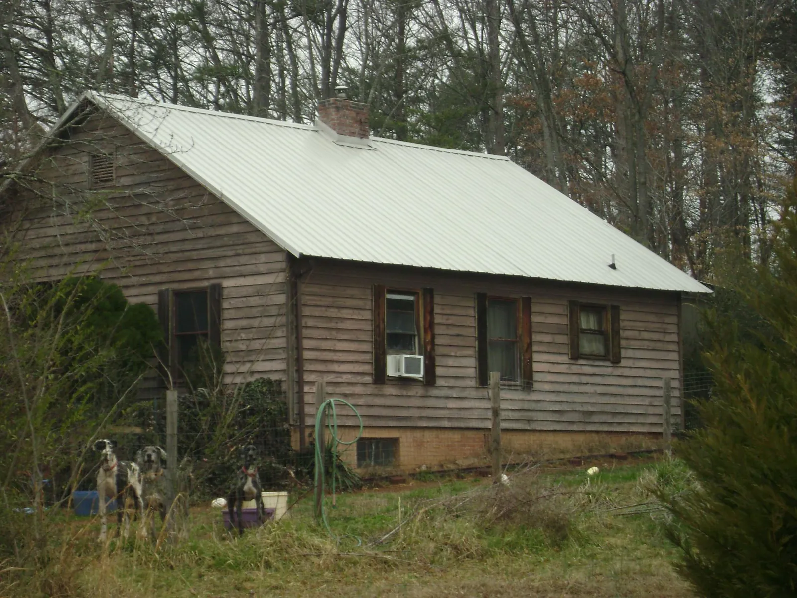 White metal roof on an old wood sided farmhouse, from a Metal Roof Installation job in Bethune